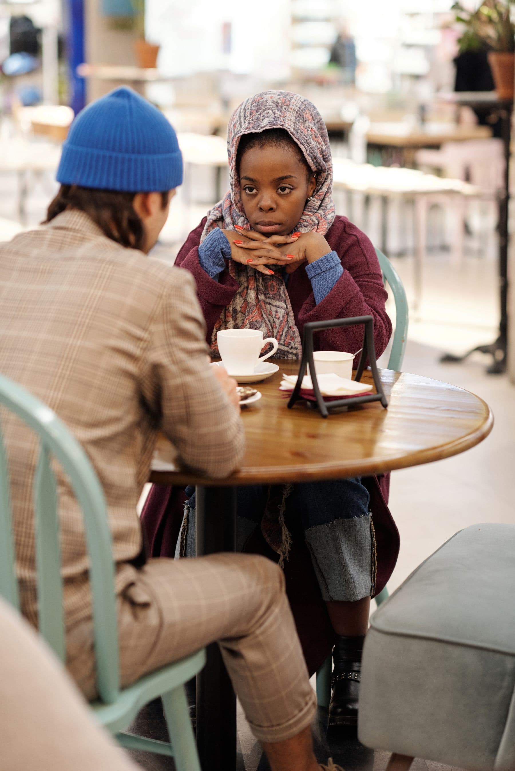 A Muslim couple having a thoughtful conversation over coffee